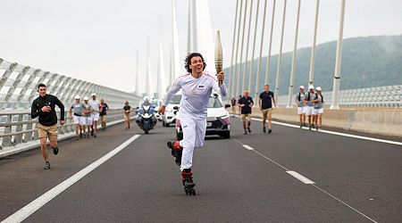 Crowds greet Olympic torch traveling through France under tight security
