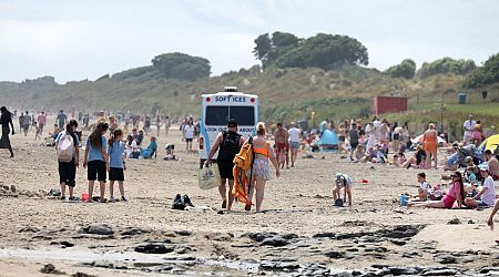 Ireland weather pictured - Beachgoers enjoy the glorious sunshine at Portmarnock beach
