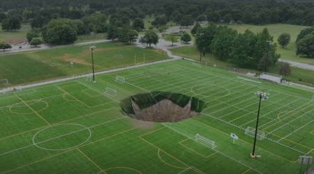 Watch the moment giant sinkhole swallows football pitch in Illinois