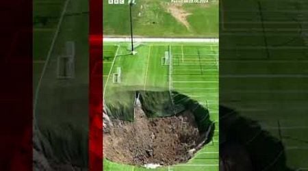 Watch moment sinkhole swallows football pitch leaving a 100 feet wide (30.5m) hole. #BBCNews