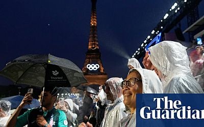 Spectators soak up Seine spectacle as rains pours on Paris