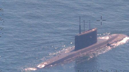 A NATO sub hunter captured these shots of a Russian submarine in waters newly surrounded by the alliance