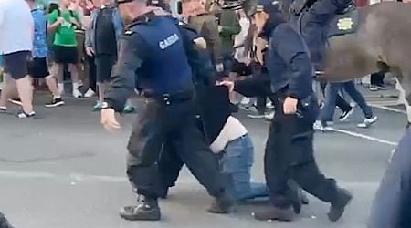 Man dragged through streets by gardai as Ireland and England fans clash in Dublin