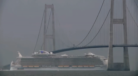 See how massive cruise ships duck under suspension bridges