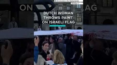 Dutch woman throws red paint on Israeli flag