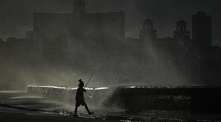 In storm and blackout, an AP photographer finds a fisherman in a sliver of natural light