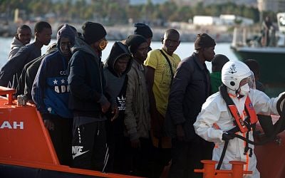 Spain will give work permits and residency to thousands of illegal migrants