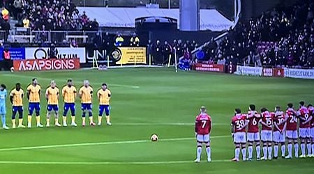 James McClean stands apart from teammates during Remembrance silence