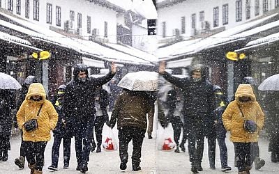 Rescuers reach a stranded hiker in Slovenia but another is missing during a Balkans snowstorm