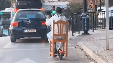 Watch: Bizarre moment Malaga local drives around on a dining chair after attaching it to his e-scooter