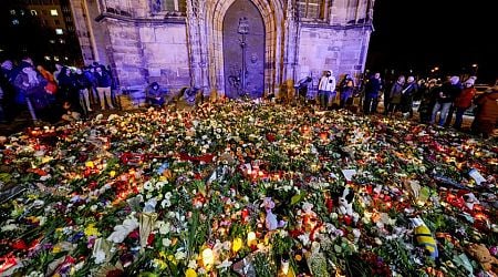 Germans mourn the 5 killed and 200 injured in the apparent attack on a Christmas market