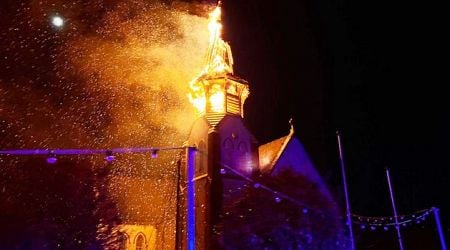 Church spire crashes to the ground in flames after lightning strike as nearby home also badly damaged