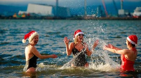 Sunshine and mild temperatures for Christmas swimmers as thousands take the plunge across the country