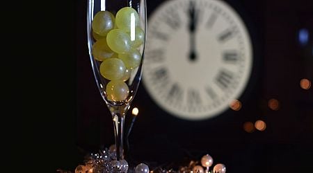 Why do locals in Spain eat 12 grapes to ring in the New Year?