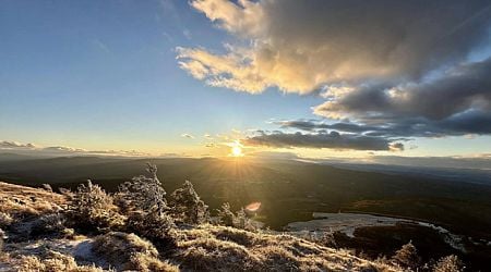 Tourists welcome the first sunset of the year on Lyubash Peak