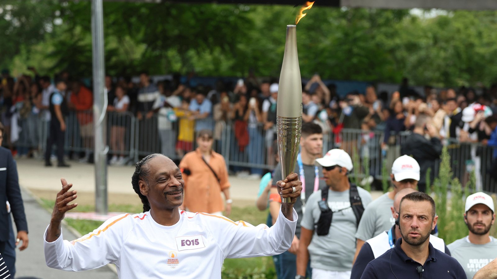 Snoop Dogg carries the Olympic torch before opening ceremony in Paris