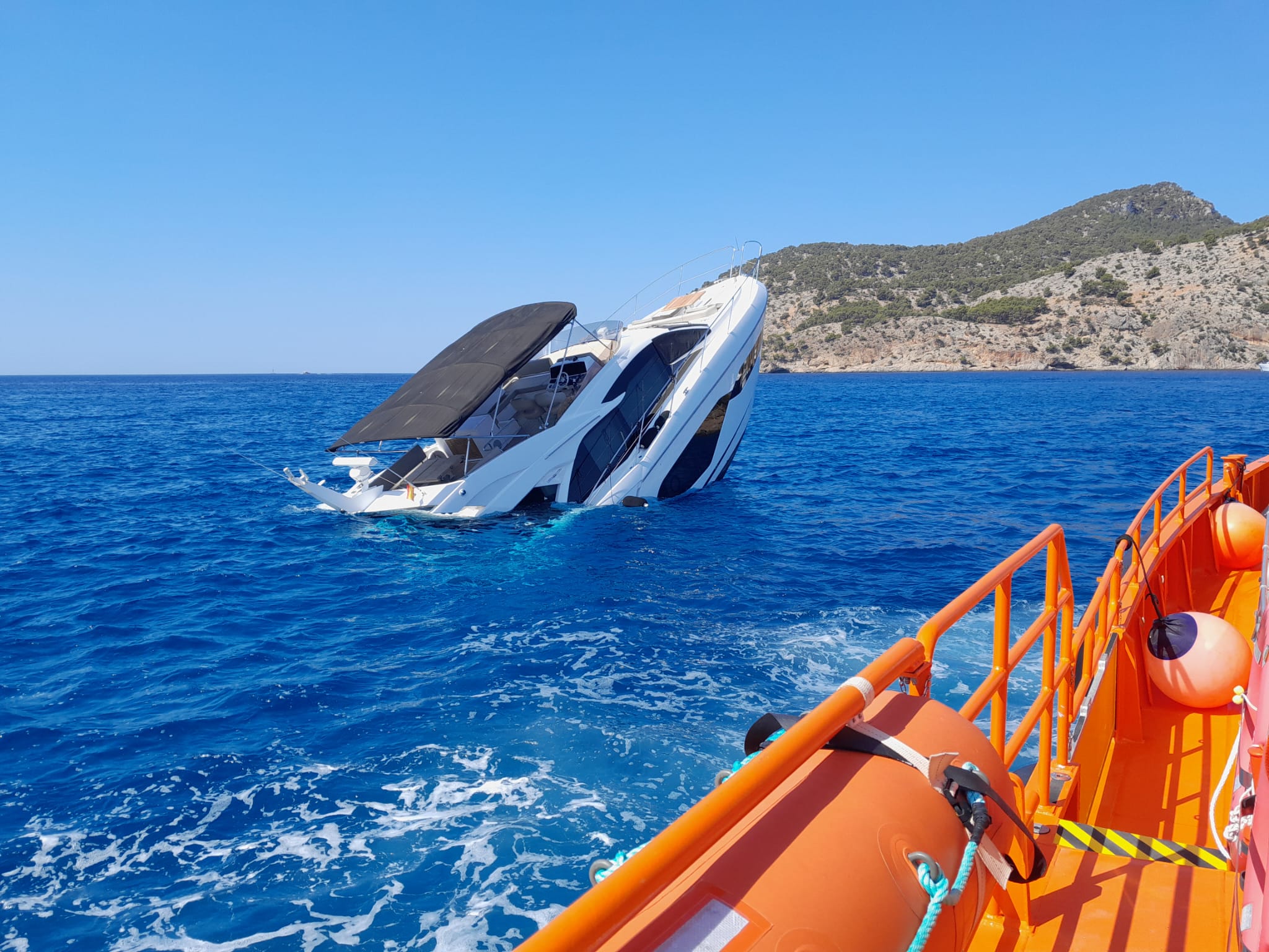 Watch: German family are rescued from their luxury yacht off the coast of Spain before it sinks to the bottom of the sea