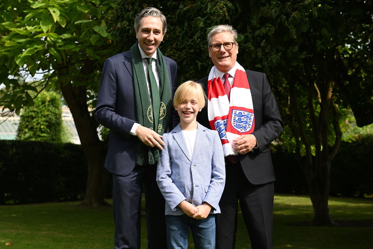 Dublin boy treated for rare illness presents premiers with football shirts