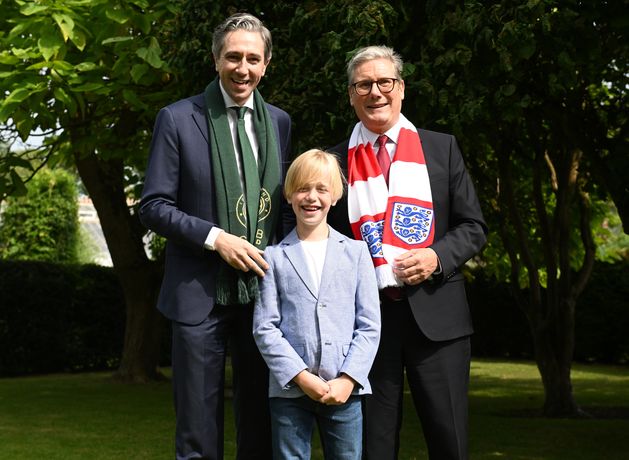 Dublin boy (9) treated for rare illness in UK presents Taoiseach and Keir Starmer with football shirts