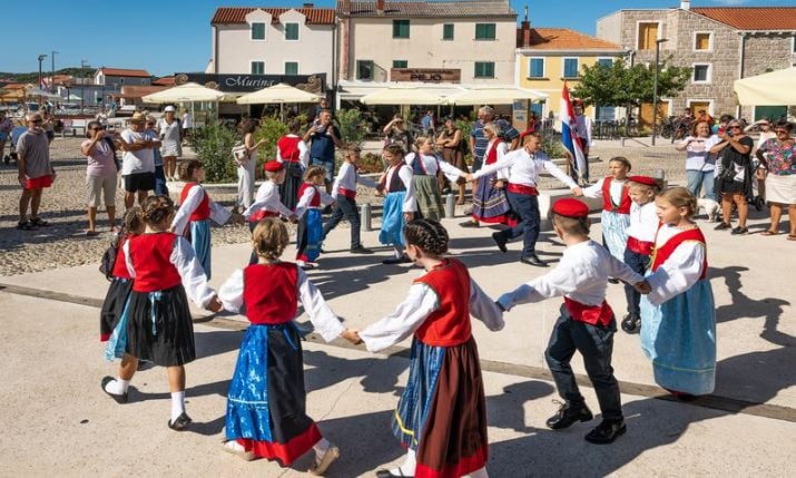 Tourists enjoy old traditions in Croatian fishing village of Betina