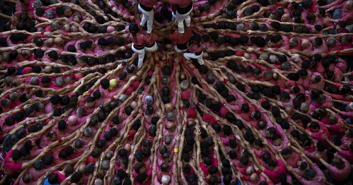 An AP photographer gets the light just right from a perch up high above a human tower competition