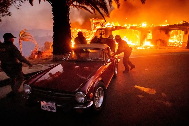 More than 10,000 people forced to evacuate in Los Angeles as out-of-control wildfire burns homes