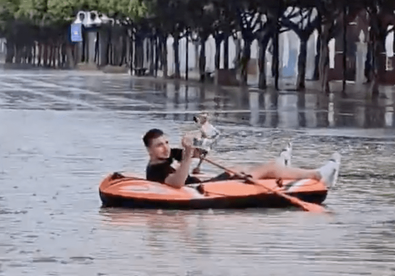 Watch: Malaga local is blasted for riding a DINGHY in flooded street during red-level storms