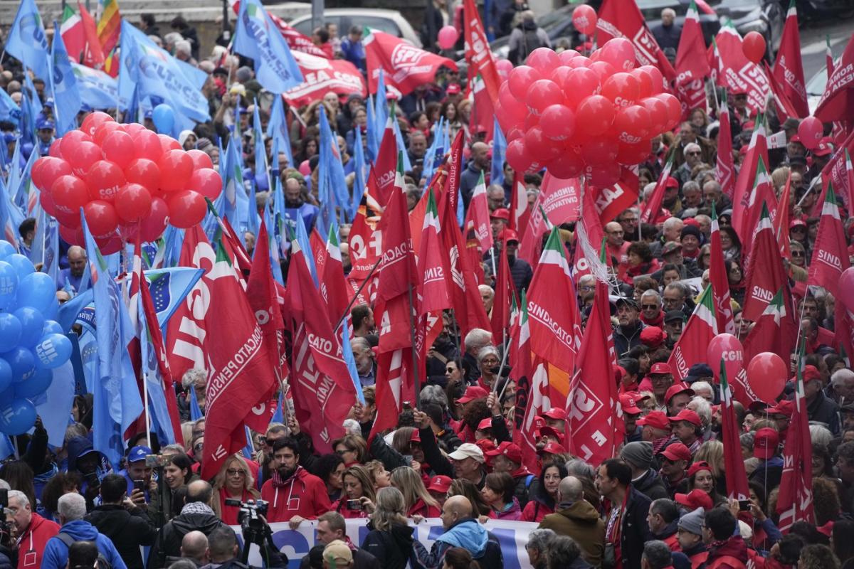 Thousands of workers march across Italy in general strike demanding better pay and services