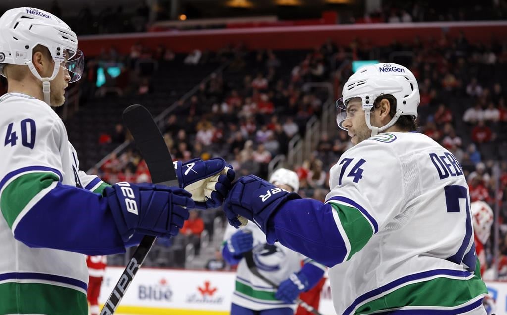 Jake DeBrusk scores hat trick, including OT game-winner, as Canucks top Red Wings 5-4