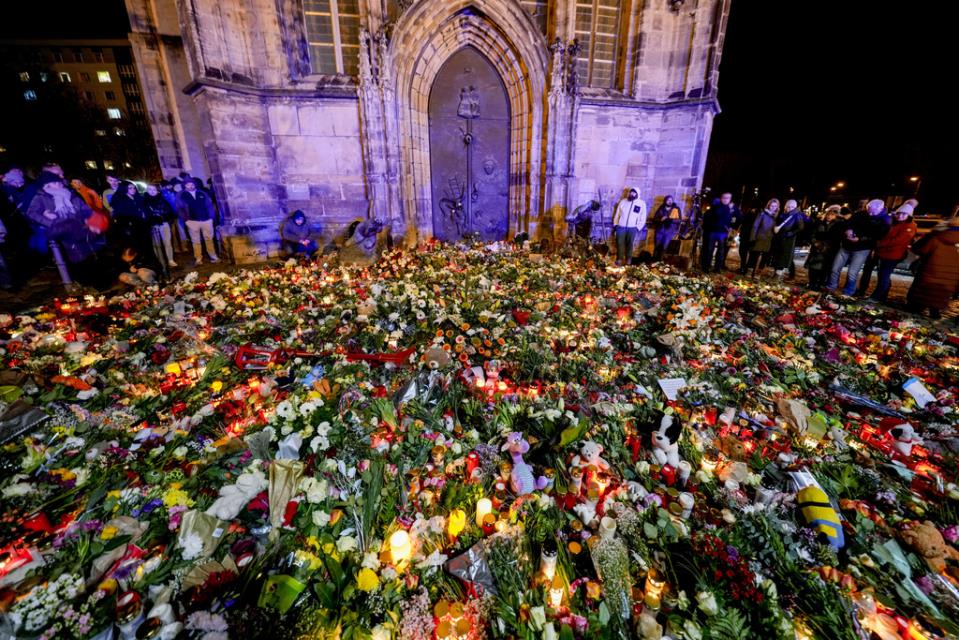 Germans mourn the 5 killed and 200 injured in the apparent attack on a Christmas market