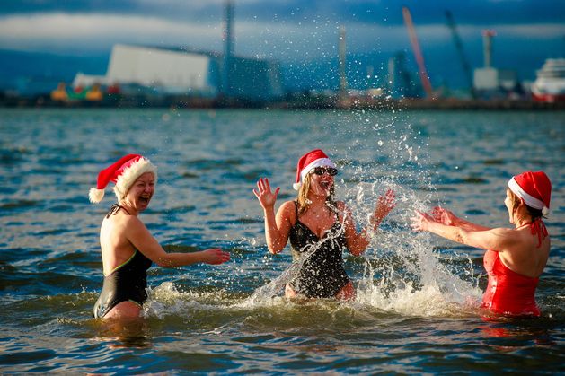 Sunshine and mild temperatures for Christmas swimmers as thousands take the plunge across the country