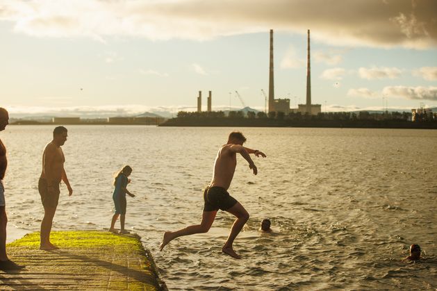 Sunshine and mild temperatures for Christmas swimmers as thousands take the plunge across the country