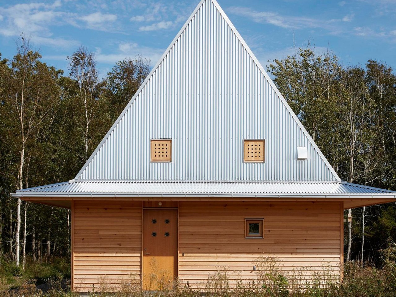 This Little Wooden Cabin On The Swedish Coast Boasts An Unusual Hat-Shaped Metal Roof